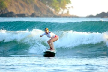 woman surfing a wave in Jaco Costa Rica