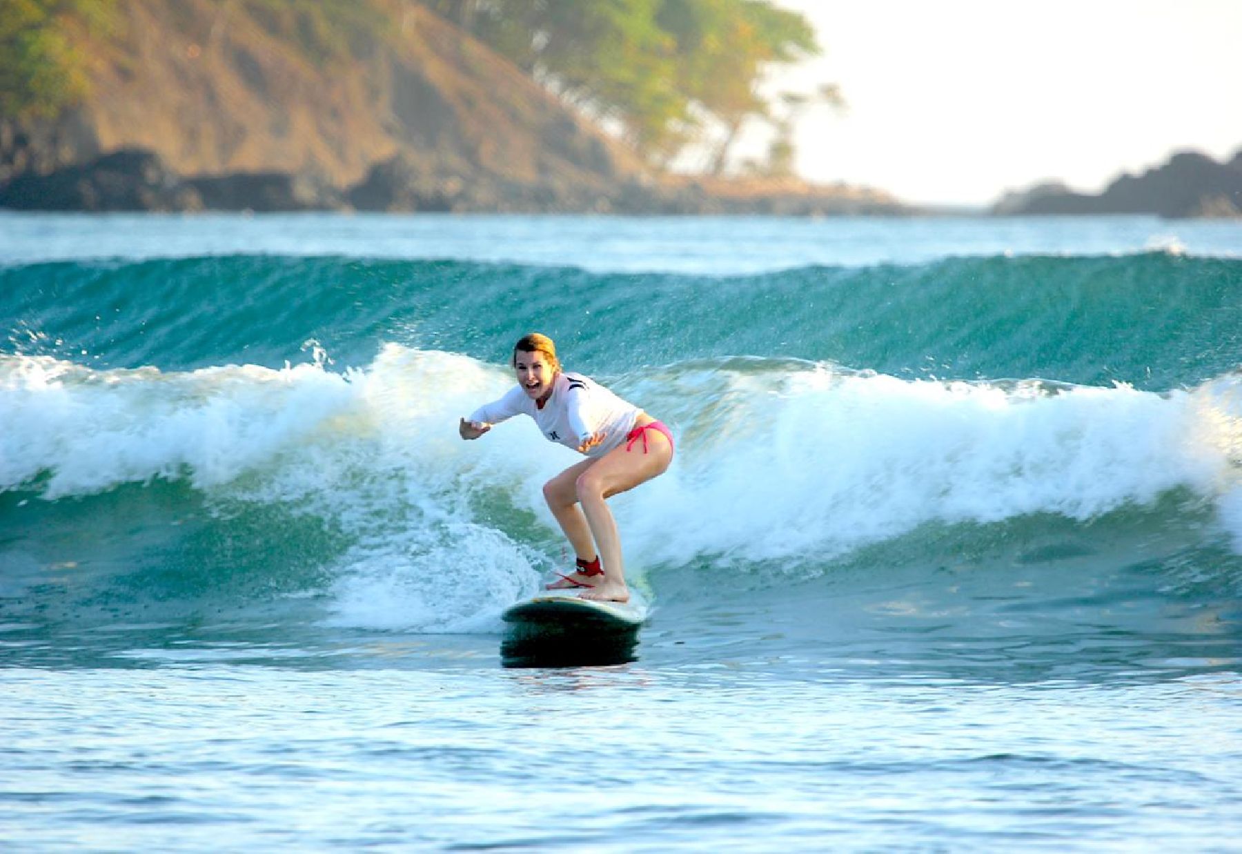 woman surfing a wave in Jaco Costa Rica