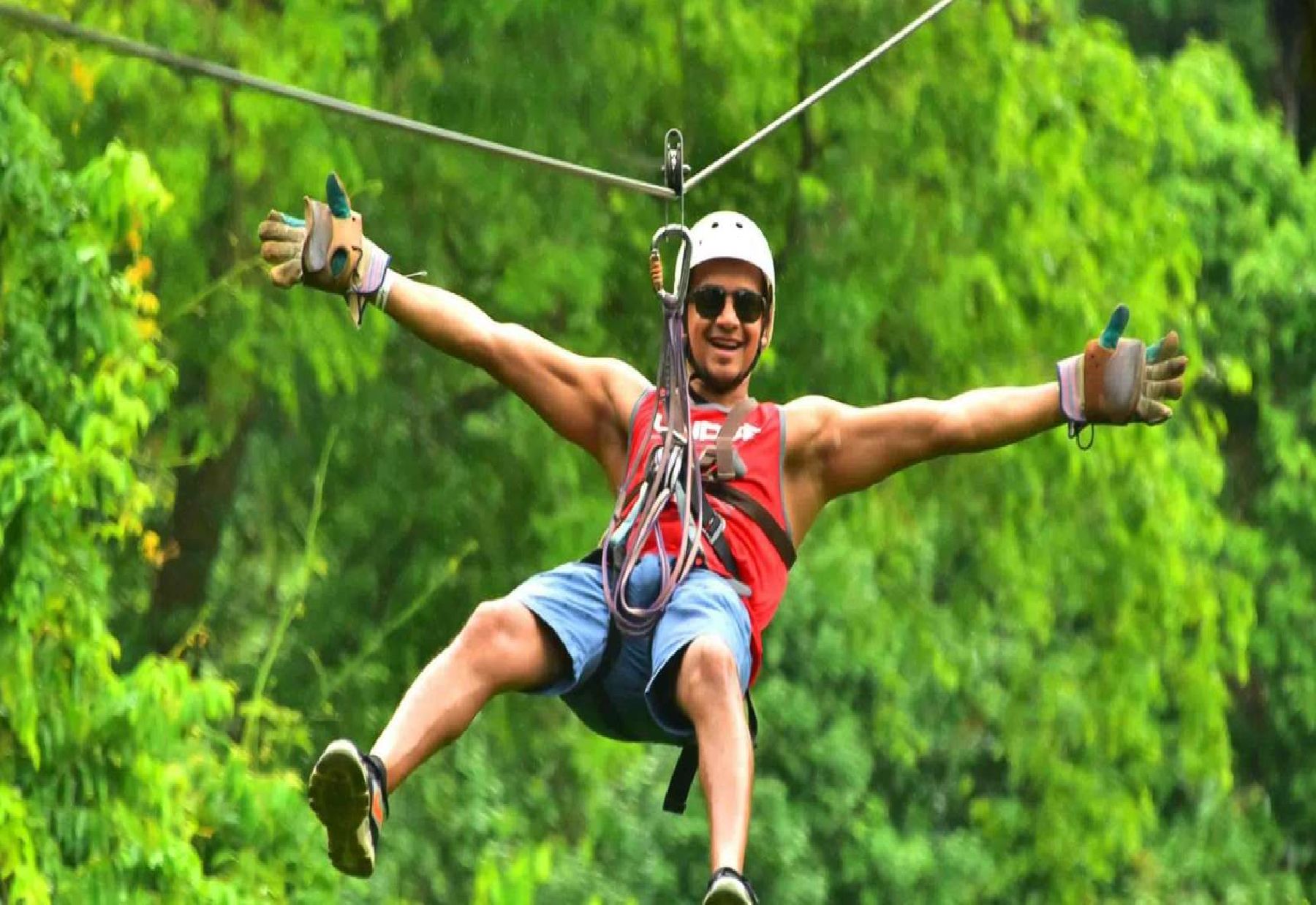 man riding a zipline in jaco costa rica