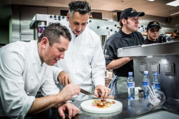 Jaco, Costa Rica villa private chefs gathered in kitchen around a new dish they prepared